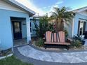 Charming single Gathering home with beautiful landscaping, seating and a welcoming front yard seating area at 6531 Seaview Blvd, Hudson, FL 34667