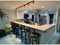 Modern kitchen featuring a long bar counter with stylish stools and lots of storage space at 6531 Seaview Blvd, Hudson, FL 34667