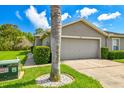 Charming one-story home with a two-car garage, well-manicured lawn, and lush landscaping at 6606 Pullen Ct, Tampa, FL 33625