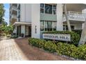 Harbour Hill building entrance showcasing the name and entrance surrounded by greenery at 700 Beach Ne Dr # 602, St Petersburg, FL 33701