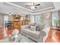 Bright open-concept living area with wood floors, neutral decor, and views into the kitchen at 708 E Patterson St, Tampa, FL 33604
