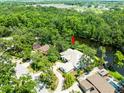 Beautiful aerial view of home and river featuring lush landscaping and mature trees at 713 Argyle Pl, Temple Terrace, FL 33617