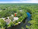 Aerial view showcasing home's river frontage surrounded by verdant trees at 713 Argyle Pl, Temple Terrace, FL 33617