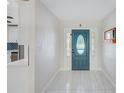 Bright foyer with stylish tile flooring and a decorative front door, creating a welcoming entrance at 9027 Merrimoor Blvd, Seminole, FL 33777
