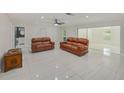 Spacious living room with tile floors and ample natural light, perfect for entertaining and relaxation at 9027 Merrimoor Blvd, Seminole, FL 33777