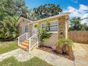Well-maintained home with stone accents, a quaint front porch, and a neatly landscaped yard at 1011 Newton S Ave, St Petersburg, FL 33705