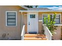 Inviting front entrance with a white door, small porch, and matching white railings at 1011 Newton S Ave, St Petersburg, FL 33705