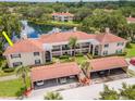 Beautiful aerial shot of a condo building near a lake with covered parking spaces at 10330 Carrollwood Ln # 95, Tampa, FL 33618