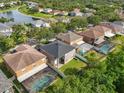 Aerial view of a suburban neighborhood with mature trees and a community pond at 11132 Creek Haven Dr, Riverview, FL 33569