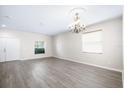 Bright living room with gray wood-look floors, light-colored walls, and natural light at 11132 Creek Haven Dr, Riverview, FL 33569