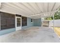 Spacious carport area offering covered parking and access to a screened-in porch at 11829 104Th St, Largo, FL 33773