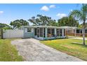 Inviting exterior view of the home with screen room and driveway at 11829 104Th St, Largo, FL 33773