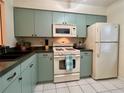 Cozy kitchen with stainless appliances, including a microwave and refrigerator at 1286 Mission Hills Blvd, Clearwater, FL 33759