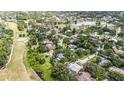 Expansive aerial view showcasing the golf course, lush greenery, community, and serene lakes at 13310 Golf Crest Cir, Tampa, FL 33618