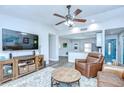 Cozy living room featuring modern furnishings, neutral tones, and an open layout to the kitchen at 14105 Farmington Blvd, Tampa, FL 33625