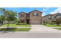 Beautiful home with a green lawn, inviting entryway, and attached two-car garage at 1613 Cabbage Key Dr, Ruskin, FL 33570
