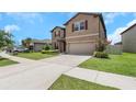 Well-kept home with a two-car garage, neat landscaping, and a welcoming walkway at 1613 Cabbage Key Dr, Ruskin, FL 33570