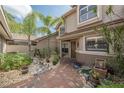 Charming courtyard entry with decorative fountain and brick-paved walkway at 17735 Oak Bridge St, Tampa, FL 33647