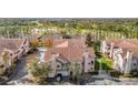 Aerial view of townhomes, showcasing community layout with trees, landscaping, and parking at 17996 Villa Creek Dr # 17996, Tampa, FL 33647