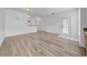 Bright living room with wood-look floors and door to outdoor living space; perfect for relaxing at 17996 Villa Creek Dr # 17996, Tampa, FL 33647