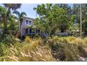 Landscaped front yard and charming two-story home nestled within lush surroundings at 1822 1St Se St, St Petersburg, FL 33705