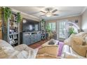 Cozy living room with a large TV, shelving unit, ceiling fan, and comfortable seating at 18439 Bridle Club Dr # 18439, Tampa, FL 33647