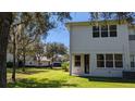 Back of home with a door that opens up to a spacious and well-maintained lawn at 19251 Stone Hedge Dr, Tampa, FL 33647