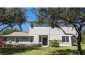 Charming two-story home with a well-manicured lawn and tasteful landscaping at 19251 Stone Hedge Dr, Tampa, FL 33647