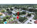 Aerial view of a residential neighborhood showcasing lush greenery and a swimming pool in the backyard at 2209 Kingswood Ln, Brandon, FL 33511