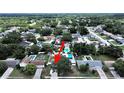Aerial view of a residential neighborhood showcasing lush greenery and a swimming pool in the backyard at 2209 Kingswood Ln, Brandon, FL 33511