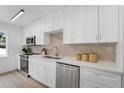 Well-equipped kitchen with stainless steel appliances, subway tile backsplash, and ample counter space at 3381 19Th Sw Pl, Largo, FL 33774