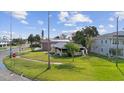 Well-maintained single-story home with lush green lawn and mature trees at 3415 Overlook Ne Dr, St Petersburg, FL 33703