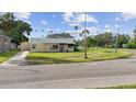 Charming single-story home with a well-manicured lawn and a detached garage at 3415 Overlook Ne Dr, St Petersburg, FL 33703