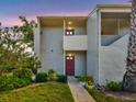 Charming condo with a inviting entrance, complemented by lush greenery and manicured landscaping at 401 Windrush Bay Dr, Tarpon Springs, FL 34689