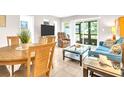 Inviting living room and dining area featuring tile floors, comfortable seating, and plenty of natural light at 401 Windrush Bay Dr, Tarpon Springs, FL 34689