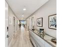 Elegant hallway featuring modern decor, recessed lighting, and a glimpse of waterfront views at 415 Island Way # 507, Clearwater Beach, FL 33767