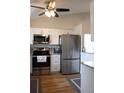 Modern kitchen features stainless steel appliances, white cabinetry and granite countertops at 4206 Revere Cir, New Port Richey, FL 34653