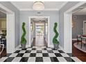 Welcoming foyer with black and white tile flooring, opening up to a lake view at 511 Windward Psge, Clearwater Beach, FL 33767