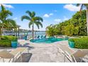 Inviting backyard with a sparkling pool, spa, lounge chairs and direct access to the channel at 511 Windward Psge, Clearwater Beach, FL 33767