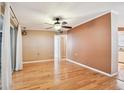 Bright living space with hardwood floors, ceiling fan, and sliding doors leading to an outdoor area at 516 Northmoor N Ave, St Petersburg, FL 33702