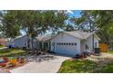Well-maintained home with an attached garage and a neatly kept lawn, showcasing curb appeal at 5323 73Rd N St, St Petersburg, FL 33709