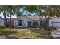Inviting home featuring a quaint front yard with lush greenery and a charming front entrance at 5323 73Rd N St, St Petersburg, FL 33709