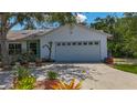 Attached garage offering ample space for parking and storage, set against a sunny backdrop at 5323 73Rd N St, St Petersburg, FL 33709