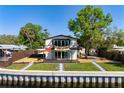 Backyard on waterfront featuring a beautiful patio, walkway and landscaping at 6814 68Th E Ave, Bradenton, FL 34203