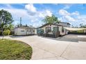 Beautiful home with a large driveway, a covered area, and a cute guest house at 6814 68Th E Ave, Bradenton, FL 34203