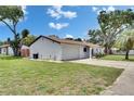 Charming single-story home with attached garage and well-maintained lawn at 8445 Angela Ct, Zephyrhills, FL 33541