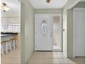 Bright foyer featuring tile flooring and a front door with decorative glass at 9120 108Th St, Seminole, FL 33772