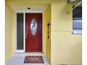 Inviting entryway featuring a red front door with decorative glass and a 'Welcome' mat at 9120 108Th St, Seminole, FL 33772