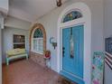 Welcoming front porch with colorful accents, stained glass and a stylish blue door at 920 Tuscanny St, Brandon, FL 33511