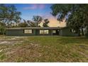 Single story home with a large manicured front yard at dusk at 9819 Allen Rd, Lithia, FL 33547